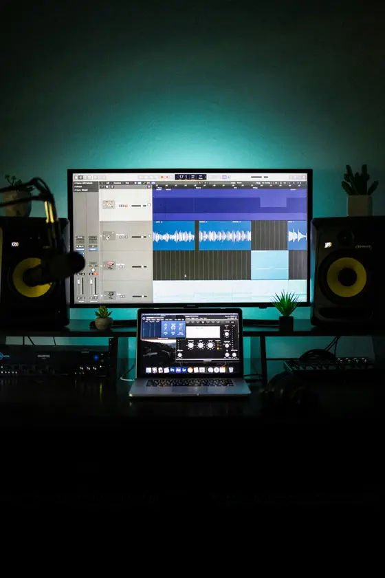 Remote broadcast mixing studio with a DAW session on screen between studio monitors